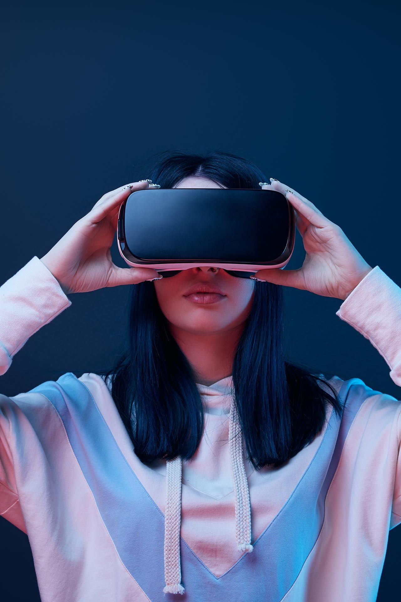 brunette young woman touching virtual reality head MGDQ6WZ